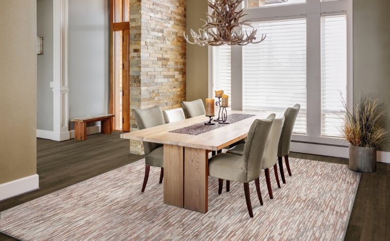 area rug in rustic dining room with chandelier